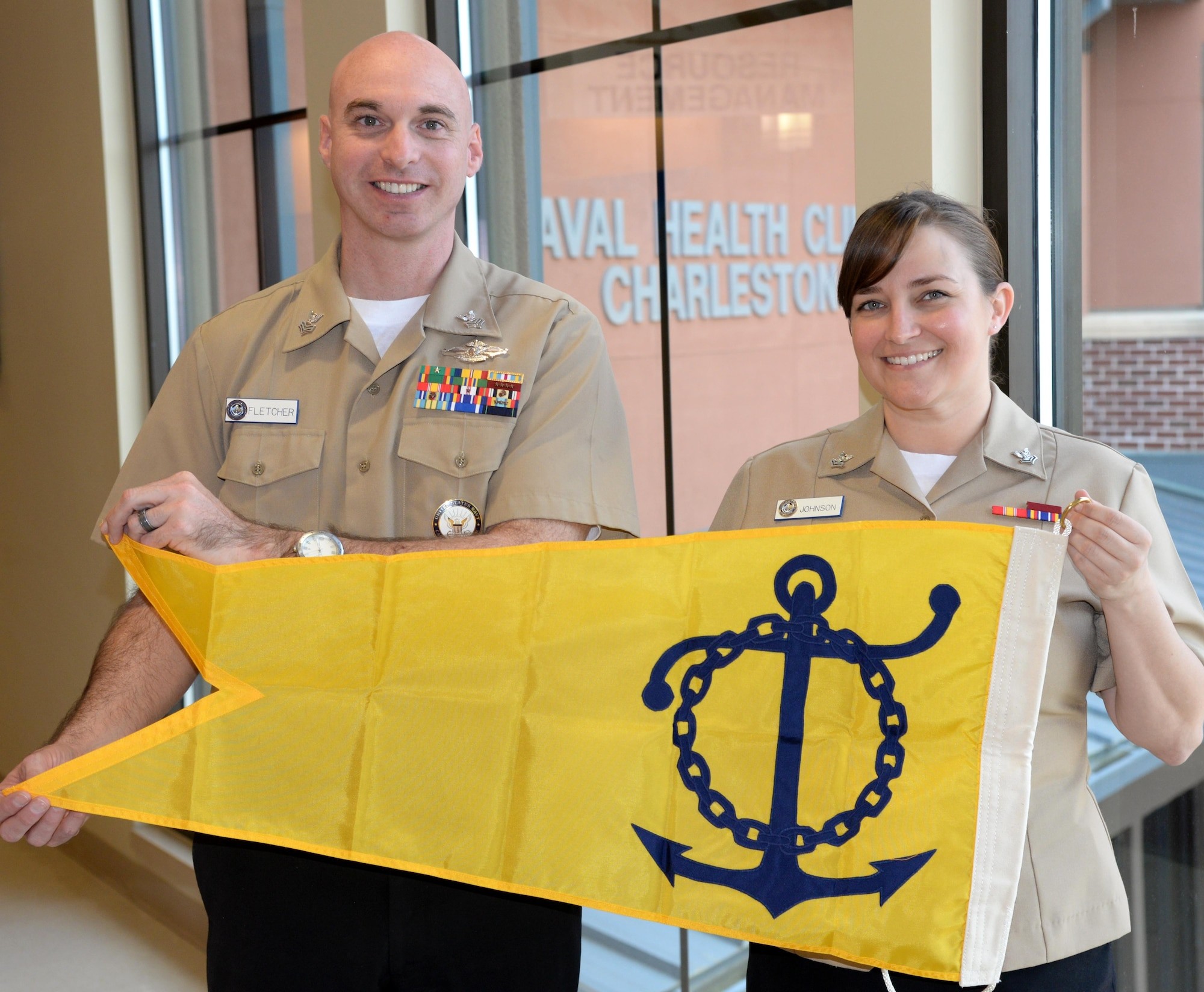 Naval Career Counselors Receive Retention Excellence Award for Career Information Program Review. Petty Officers Fletcher and Johnson of Naval Health Clinic Charleston display the award pennant, recognizing their successful Career Information Program Review.