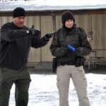 Law enforcement students training outdoors as part of their Administration of Justice career degree program