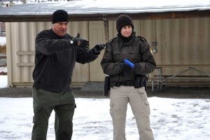 Law enforcement students training outdoors as part of their Administration of Justice career degree program