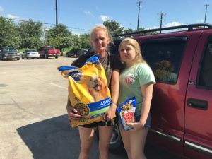 Family with dog receiving pet food assistance