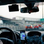 DoorDash driver using navigation in a rental car obtained through a program like Carla App, highlighting the flexibility of car rental for gig economy delivery jobs.