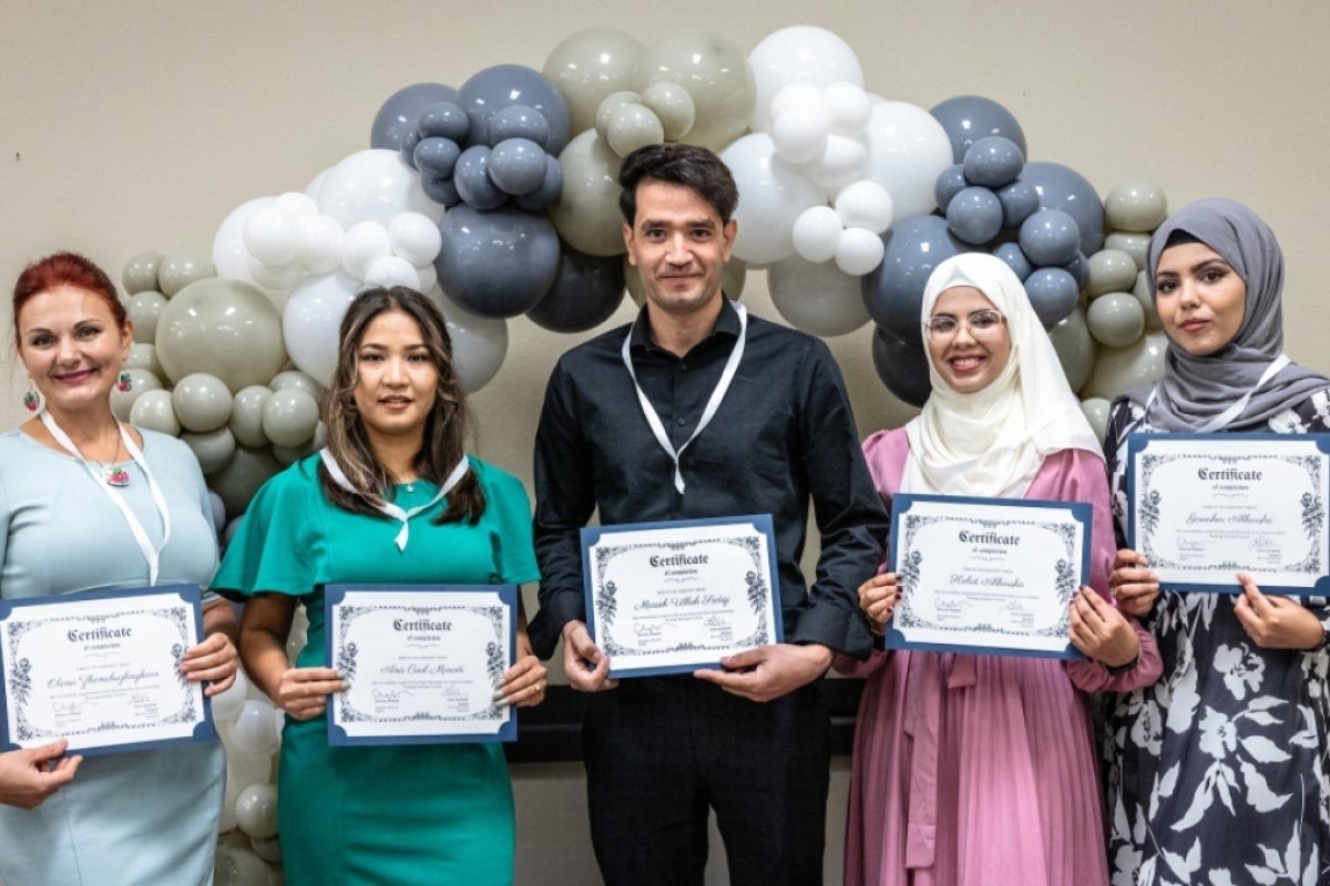 Refugee graduates of ASU CNA program showcase their certificates with pride