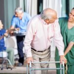 Maine Long Term Care Ombudsman Program: A compassionate nurse aids a senior resident with a walker, symbolizing advocacy and support for elderly care.