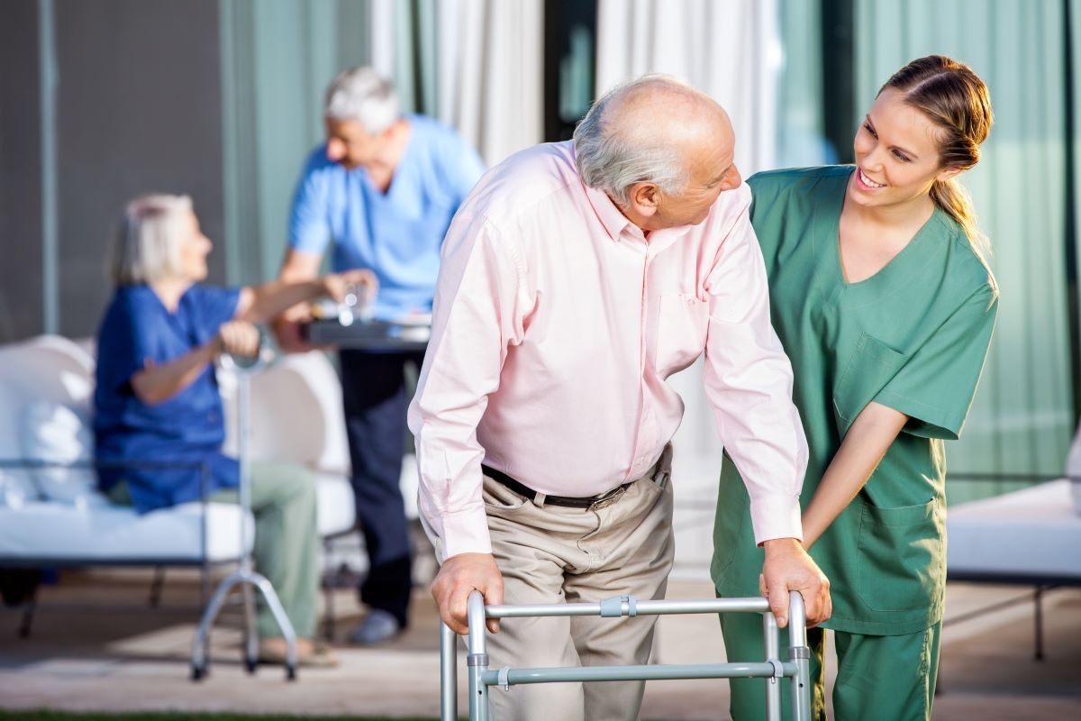 Maine Long Term Care Ombudsman Program: A compassionate nurse aids a senior resident with a walker, symbolizing advocacy and support for elderly care.